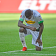 Monchenbladbach’s Marcus Thuram takes a knee after scoring a goal Sunday.